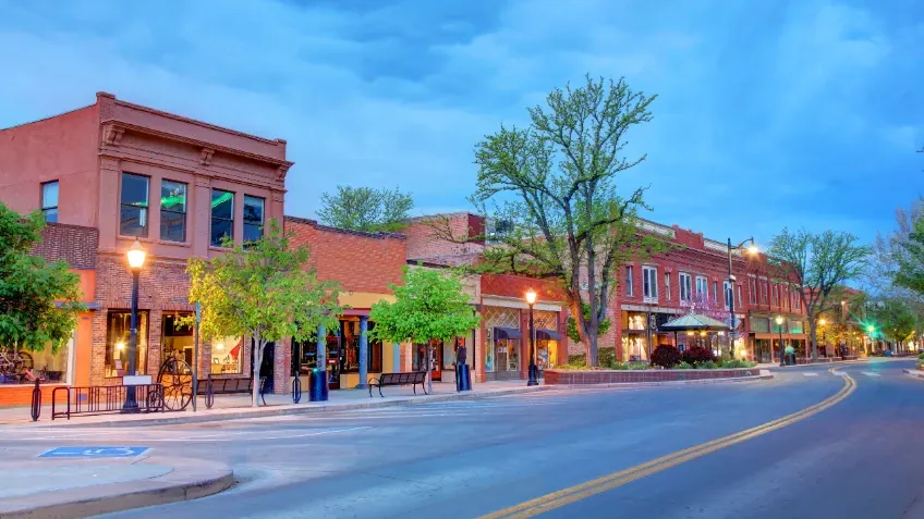Brick storefronts on Main Street in downtown Grand Junction at dusk
